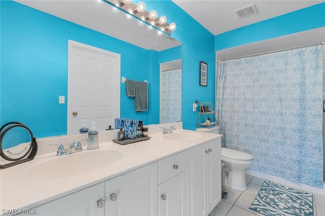 bathroom featuring toilet, vanity, tile patterned floors, and walk in shower