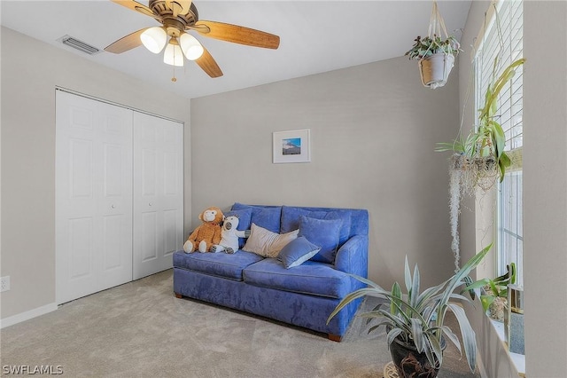 interior space featuring light carpet and ceiling fan