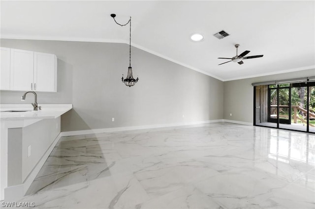 interior space featuring white cabinetry, ceiling fan, ornamental molding, and sink