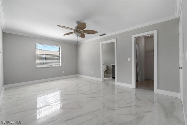 empty room featuring ceiling fan and crown molding