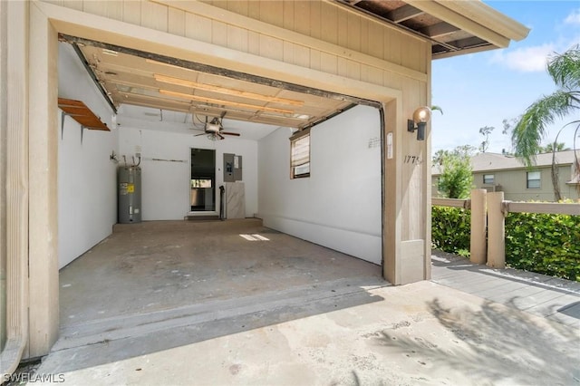 garage with ceiling fan, electric panel, and water heater