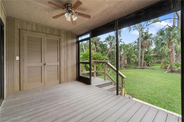 unfurnished sunroom featuring ceiling fan and wood ceiling