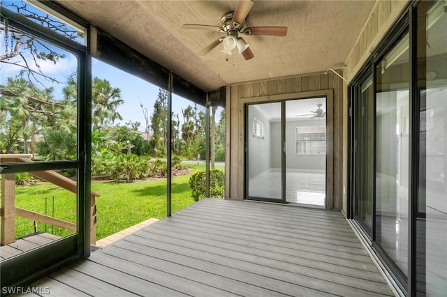 unfurnished sunroom featuring ceiling fan and wood ceiling