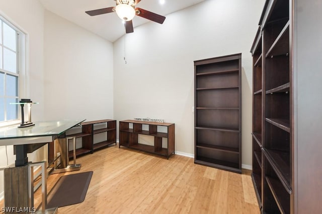 living room featuring light wood-type flooring and ceiling fan