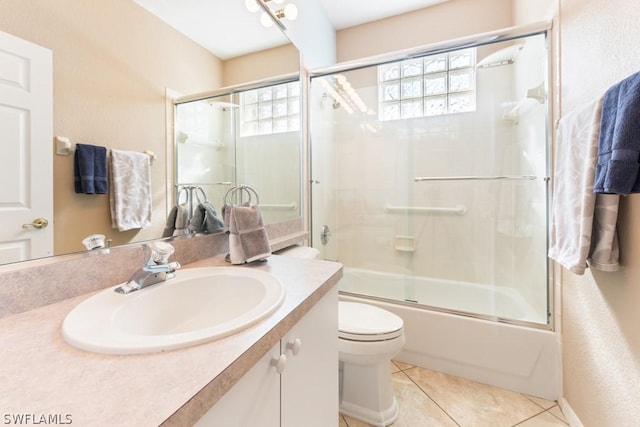 full bathroom featuring shower / bath combination with glass door, tile patterned floors, plenty of natural light, and toilet