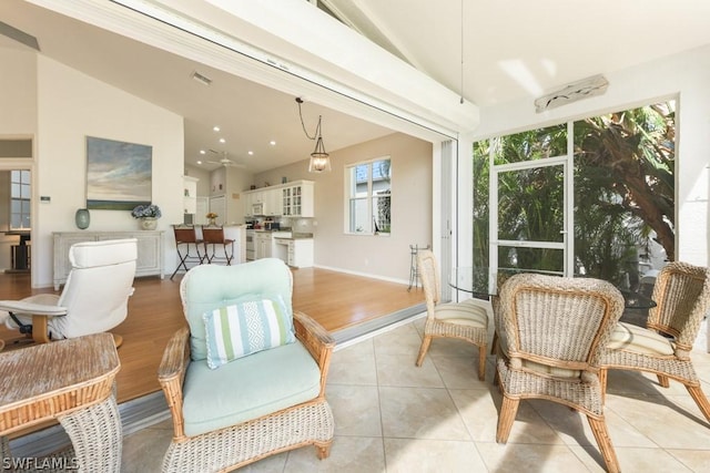 sunroom featuring vaulted ceiling and ceiling fan