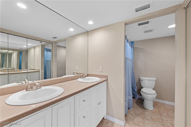 bathroom with tile patterned floors, a shower with shower curtain, vanity, and toilet