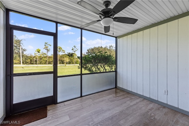 unfurnished sunroom with ceiling fan