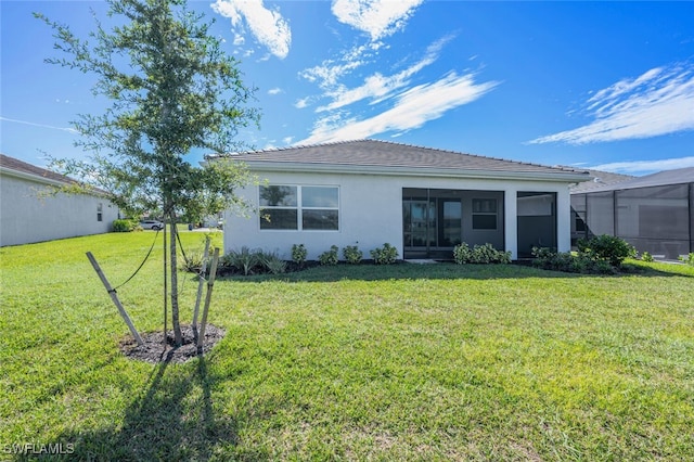 rear view of house featuring a yard