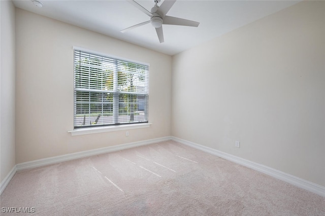 empty room featuring light carpet and ceiling fan