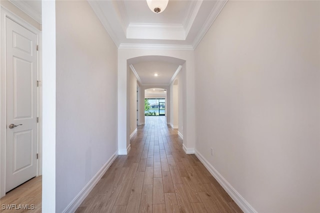 hall with light hardwood / wood-style floors and ornamental molding