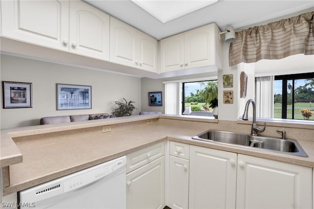 kitchen with sink, white cabinets, a healthy amount of sunlight, and dishwasher