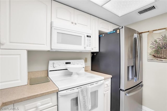 kitchen with white appliances and white cabinetry