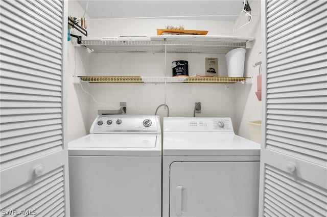 clothes washing area featuring separate washer and dryer