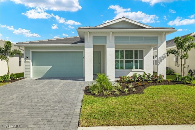 view of front facade with a garage and a front lawn