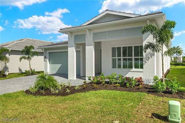 view of front of home featuring a garage and a front lawn