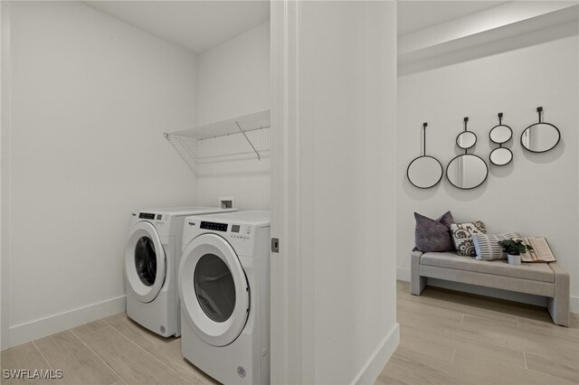 clothes washing area with washing machine and clothes dryer