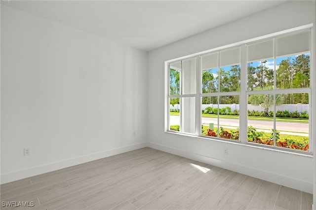 spare room featuring light hardwood / wood-style flooring