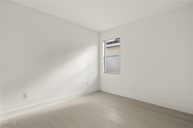 empty room with light hardwood / wood-style flooring