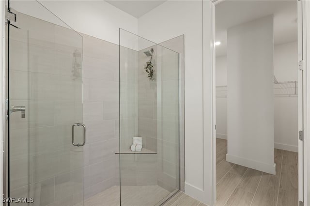 bathroom featuring a shower with shower door