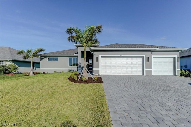 single story home featuring a garage and a front yard