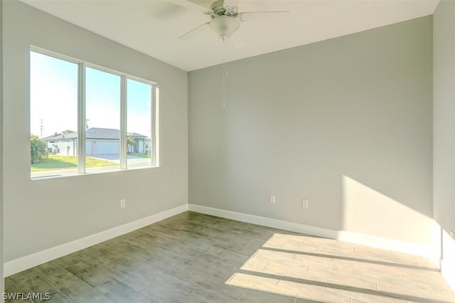 spare room featuring light hardwood / wood-style flooring and ceiling fan