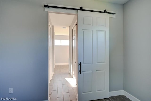 corridor featuring a barn door