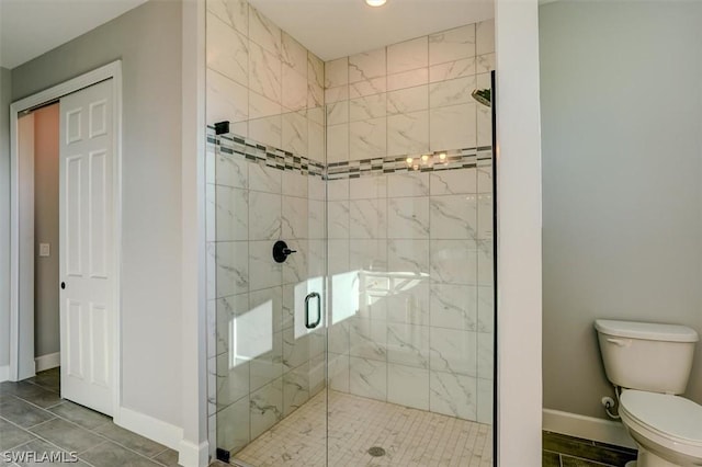 bathroom with toilet and an enclosed shower