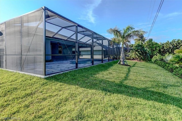 view of yard featuring a swimming pool and glass enclosure