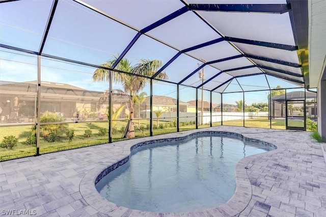 view of swimming pool with a patio and glass enclosure