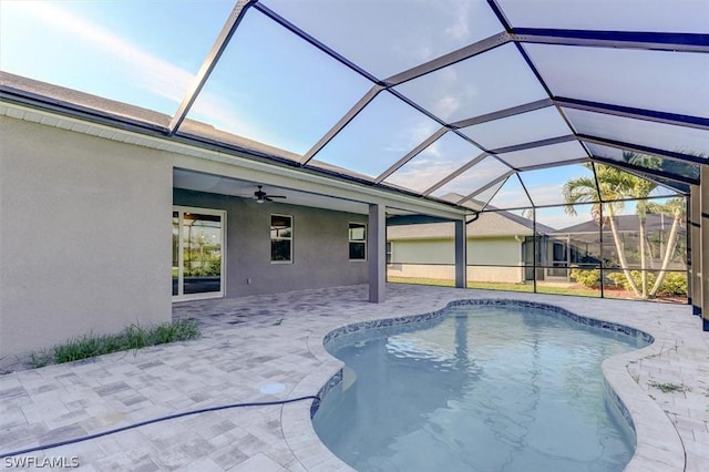 view of swimming pool with a lanai, a patio area, and ceiling fan