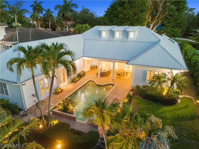 rear view of house featuring a lawn, a patio area, and an outdoor living space