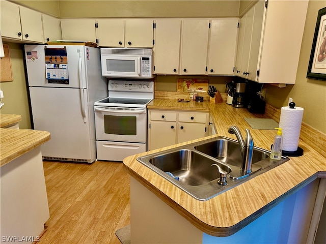 kitchen with sink, light hardwood / wood-style floors, white appliances, and white cabinetry