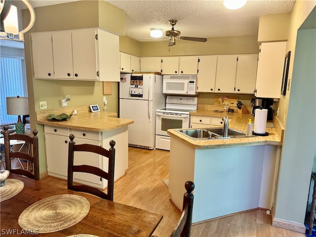 kitchen featuring white cabinets, ceiling fan, white appliances, and kitchen peninsula