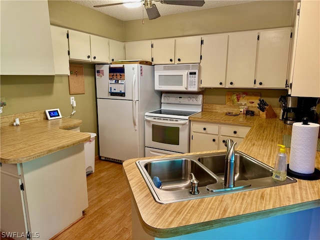 kitchen featuring light hardwood / wood-style floors, white appliances, white cabinets, kitchen peninsula, and ceiling fan