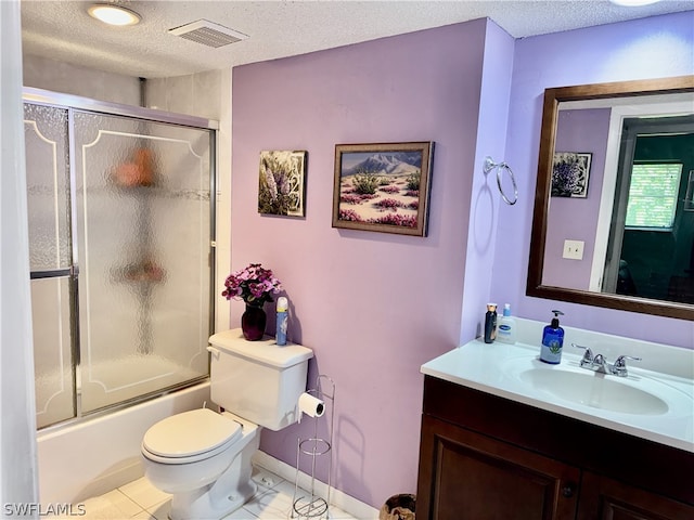 full bathroom featuring tile flooring, a textured ceiling, enclosed tub / shower combo, toilet, and vanity