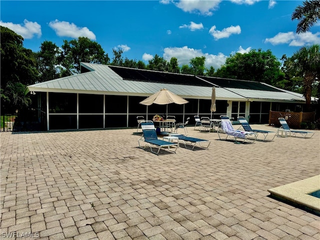 view of pool with a patio area and a sunroom