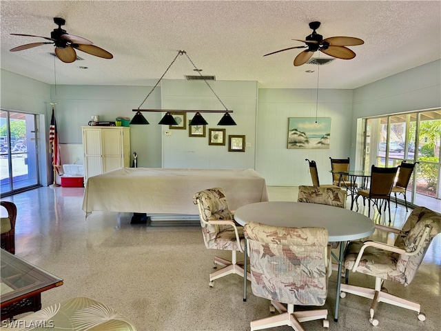 dining room with a textured ceiling and ceiling fan