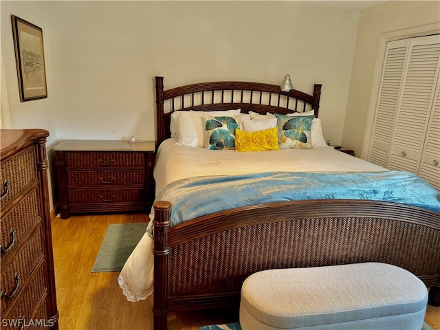 bedroom with hardwood / wood-style flooring and a closet