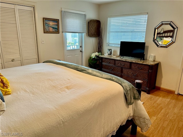 bedroom featuring a closet and light hardwood / wood-style flooring