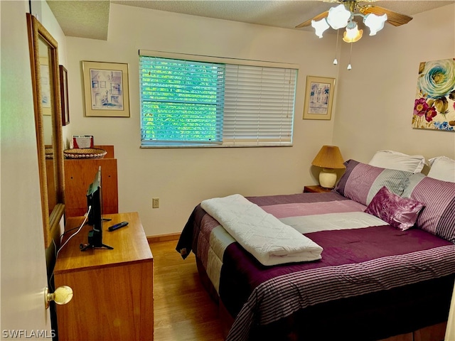 bedroom with ceiling fan and wood-type flooring