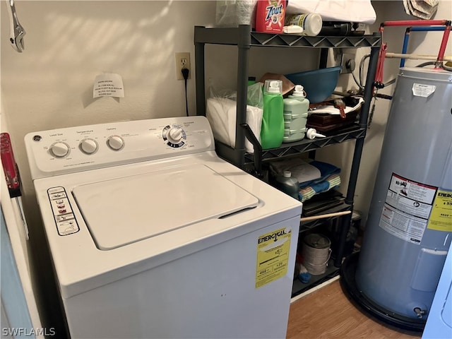 laundry area featuring washer / dryer, wood-type flooring, and water heater