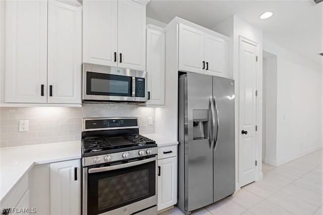 kitchen featuring white cabinetry, light countertops, tasteful backsplash, and stainless steel appliances