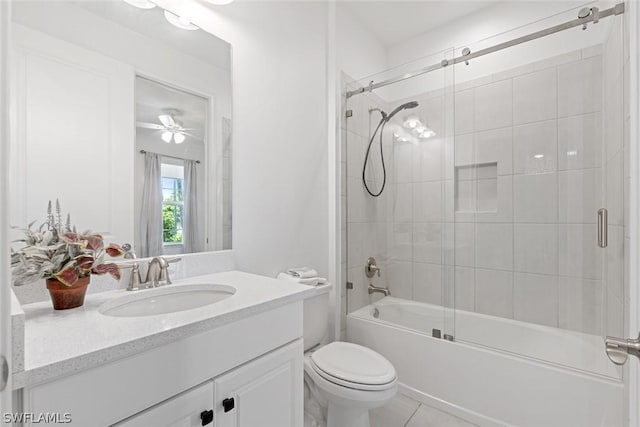 bathroom featuring enclosed tub / shower combo, toilet, vanity, and tile patterned flooring