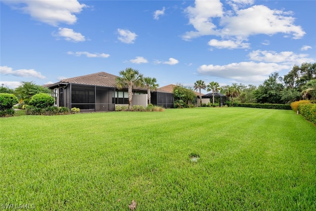 view of yard featuring a sunroom