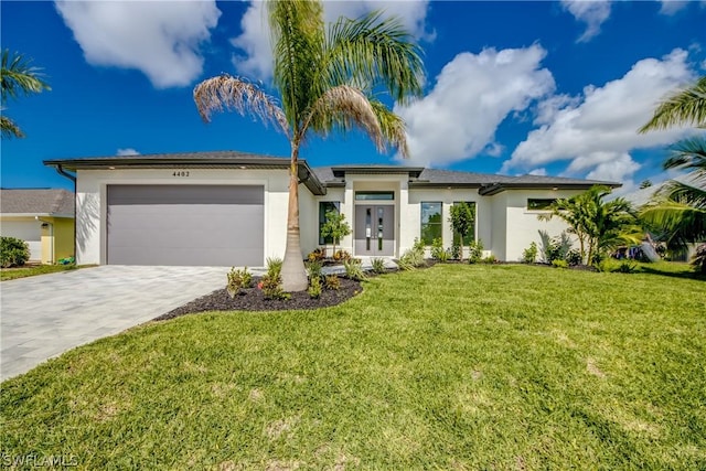 view of front of house featuring a garage and a front lawn