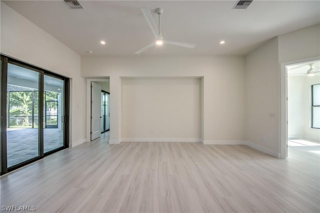 empty room with ceiling fan and light wood-type flooring