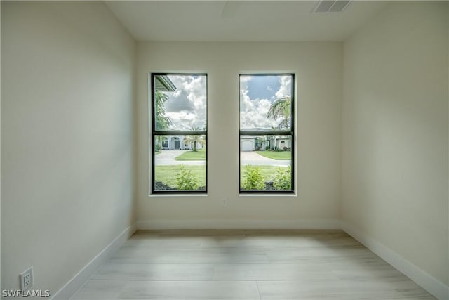 unfurnished room with light wood-type flooring