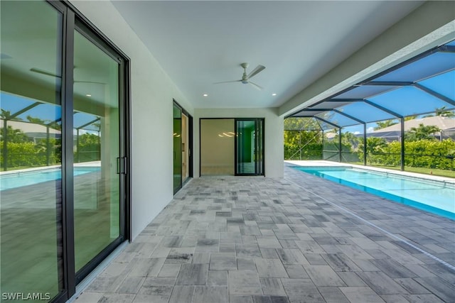 view of swimming pool featuring a lanai, a patio area, and ceiling fan