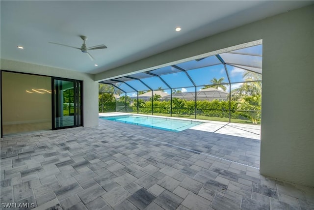 view of swimming pool with a patio area and a lanai